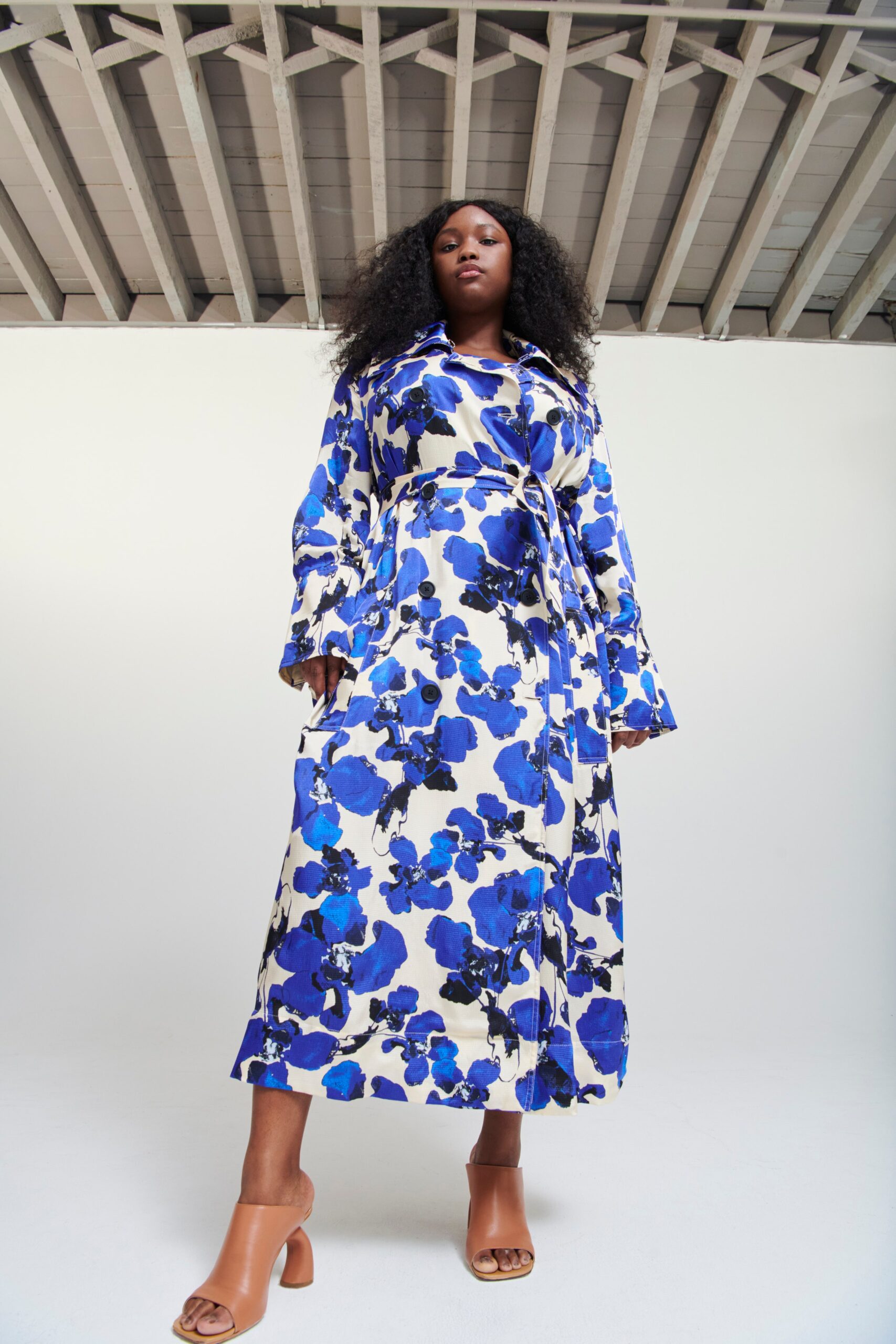 A relaxed floral blue and white dress with long sleeves and a collared neckline.