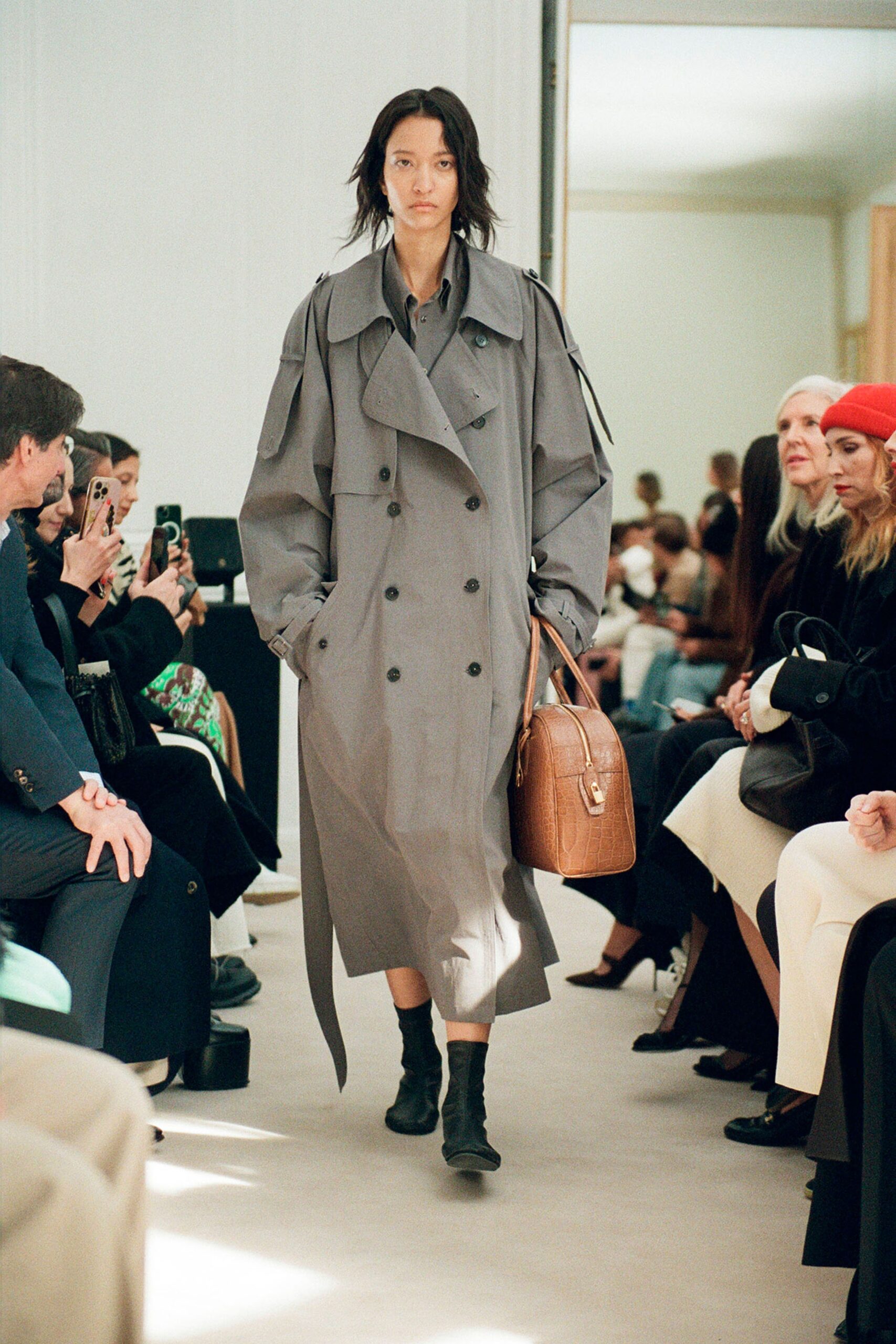 An oversized gray cotton trench coat with long sleeves and a collared design.
