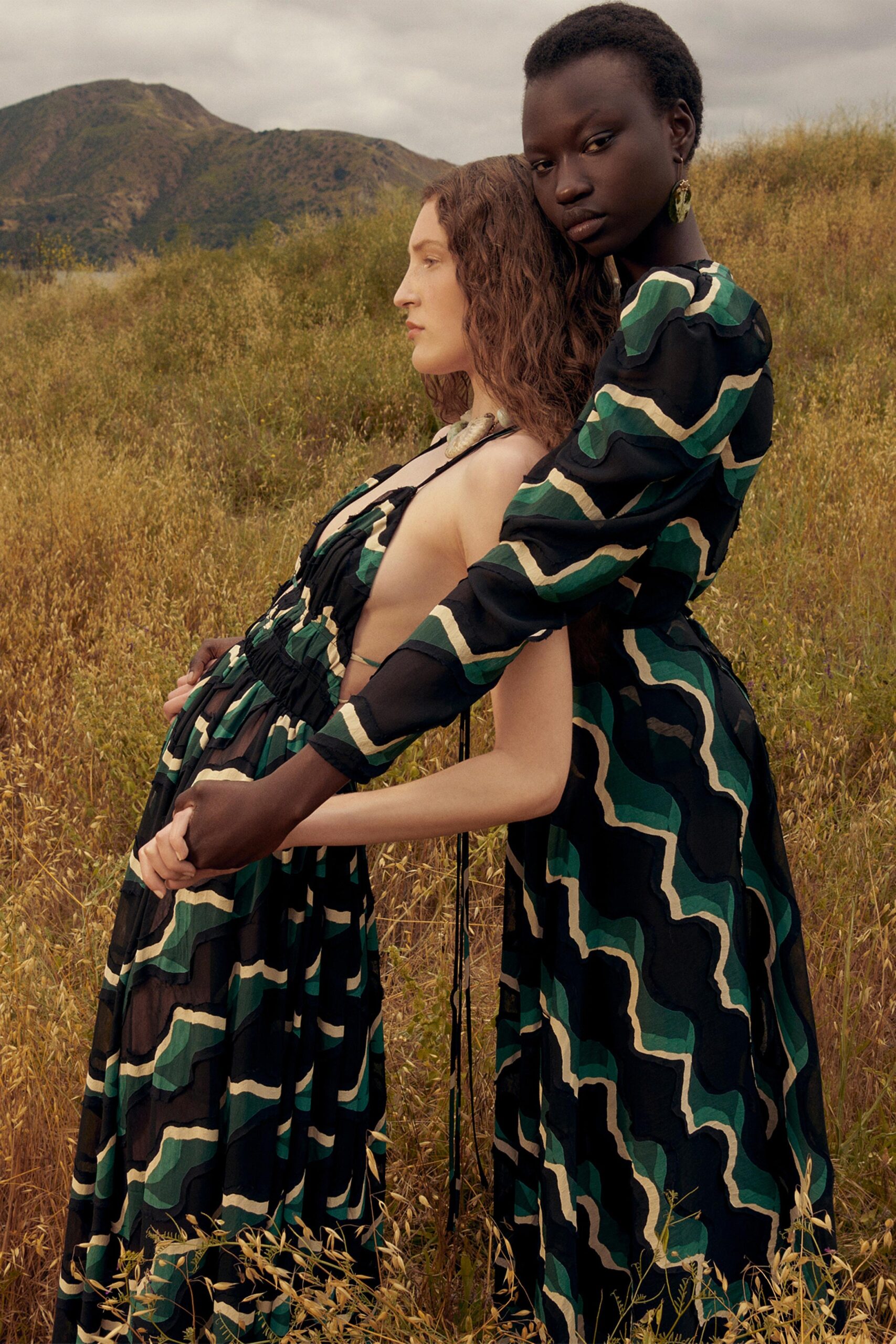A relaxed green and black printed dress with long sleeves and a V-neckline.