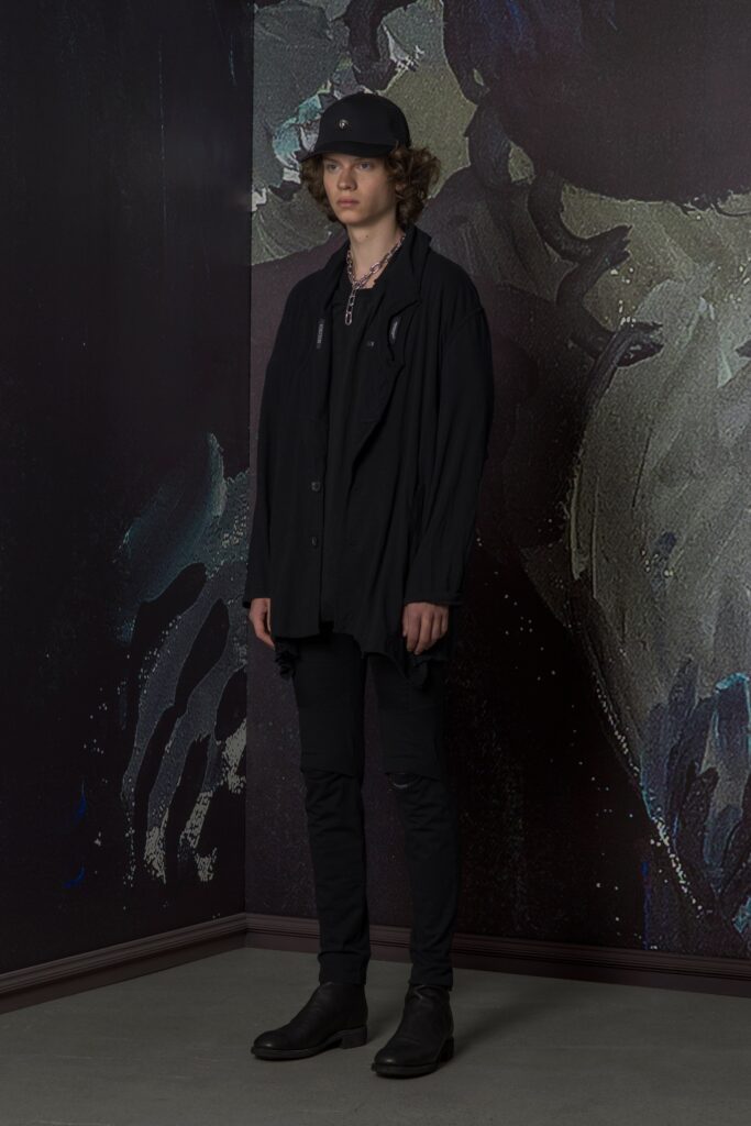 A relaxed black jacket with long sleeves and collared design paired with matching pants.