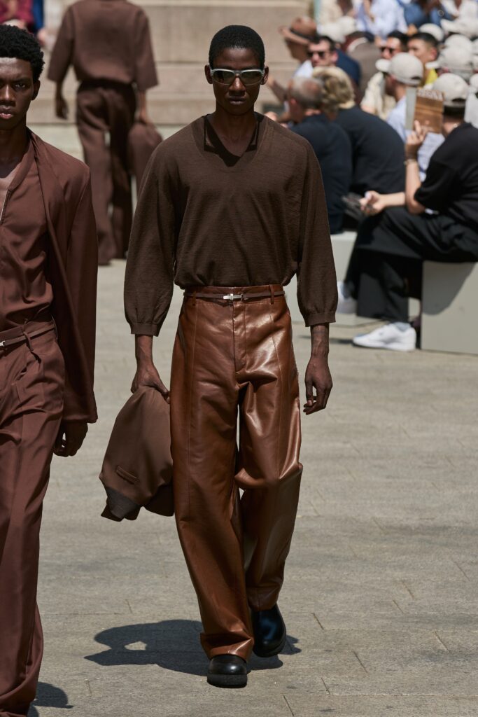 Relaxed brown leather pants with a long-sleeve collared top and wide-leg design.