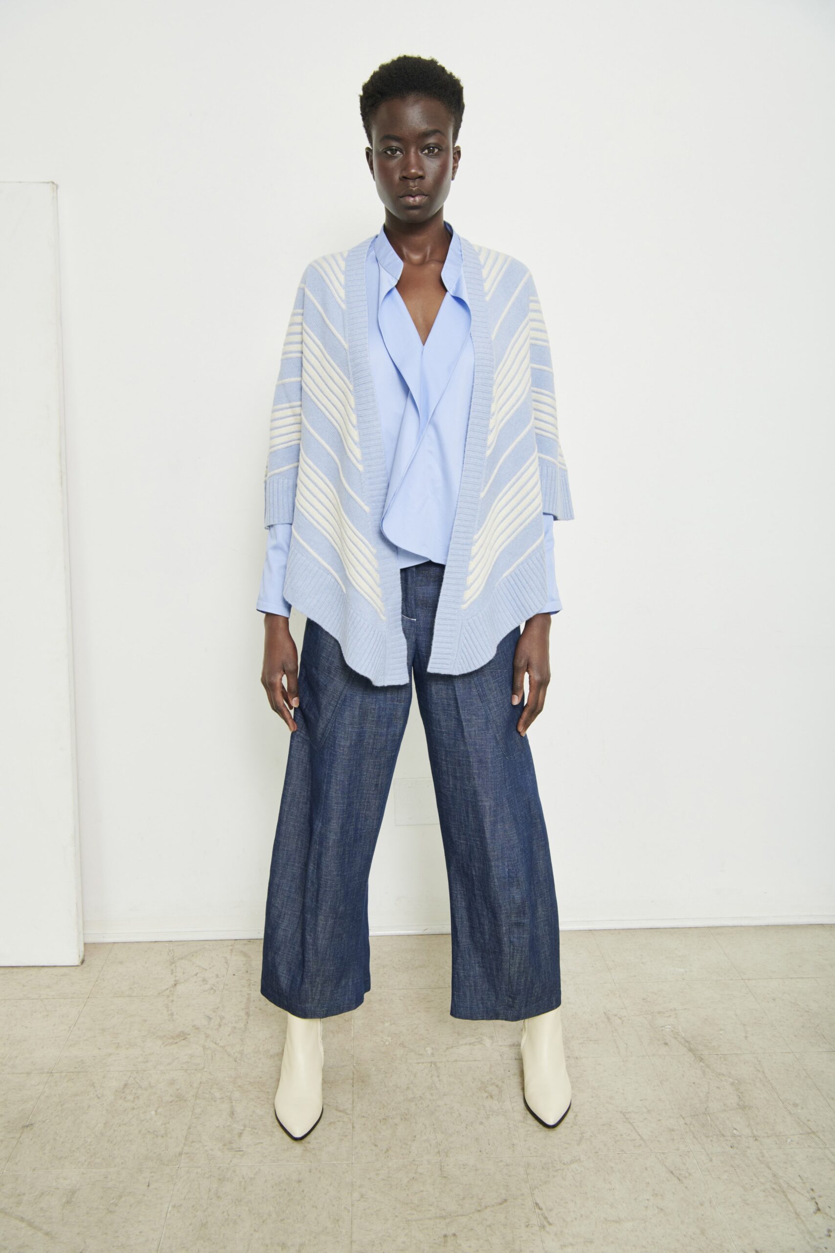 A relaxed blue striped top paired with wide-leg denim pants for a casual look.
