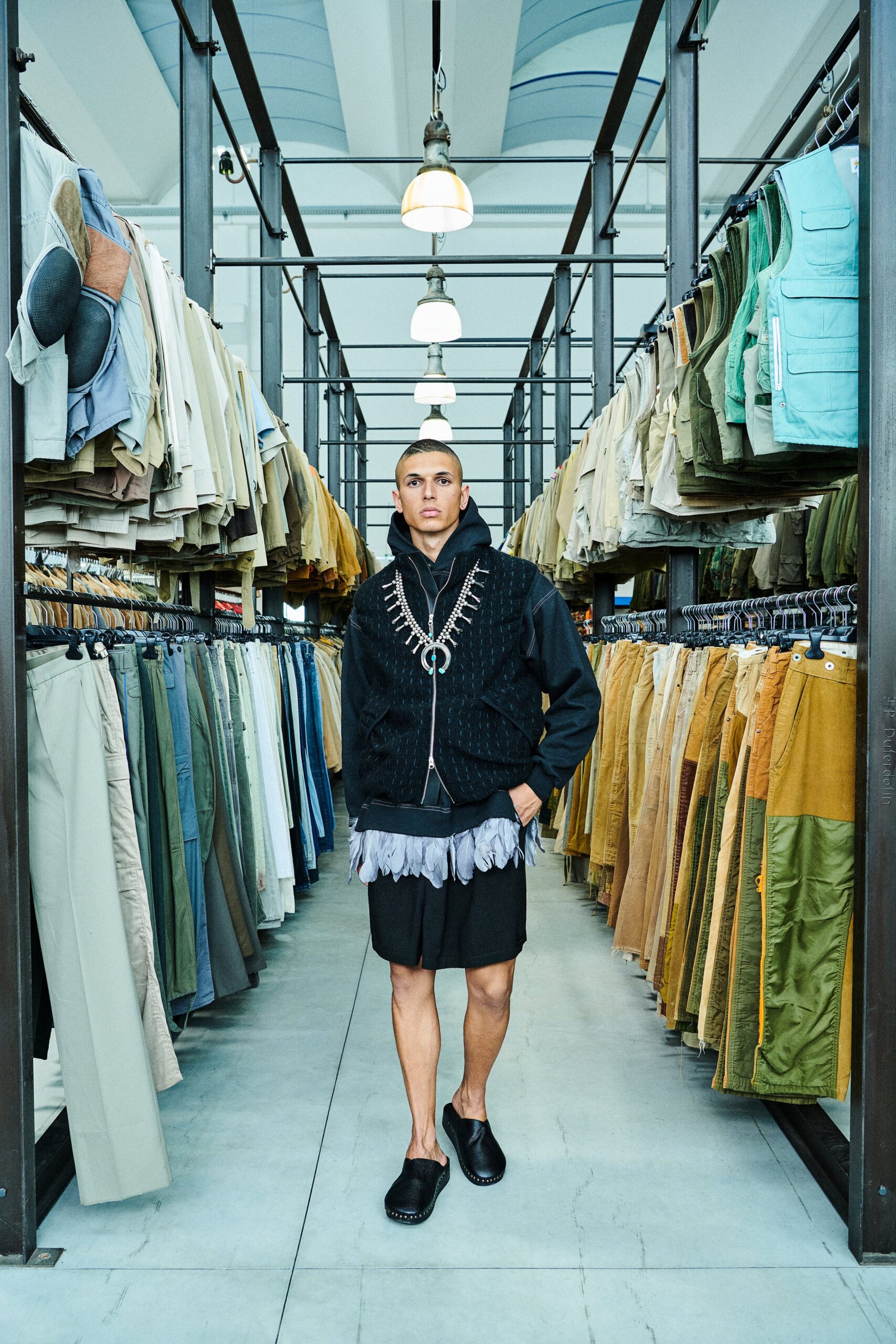 A relaxed black hoodie with long sleeves and layered shorts for a casual look.