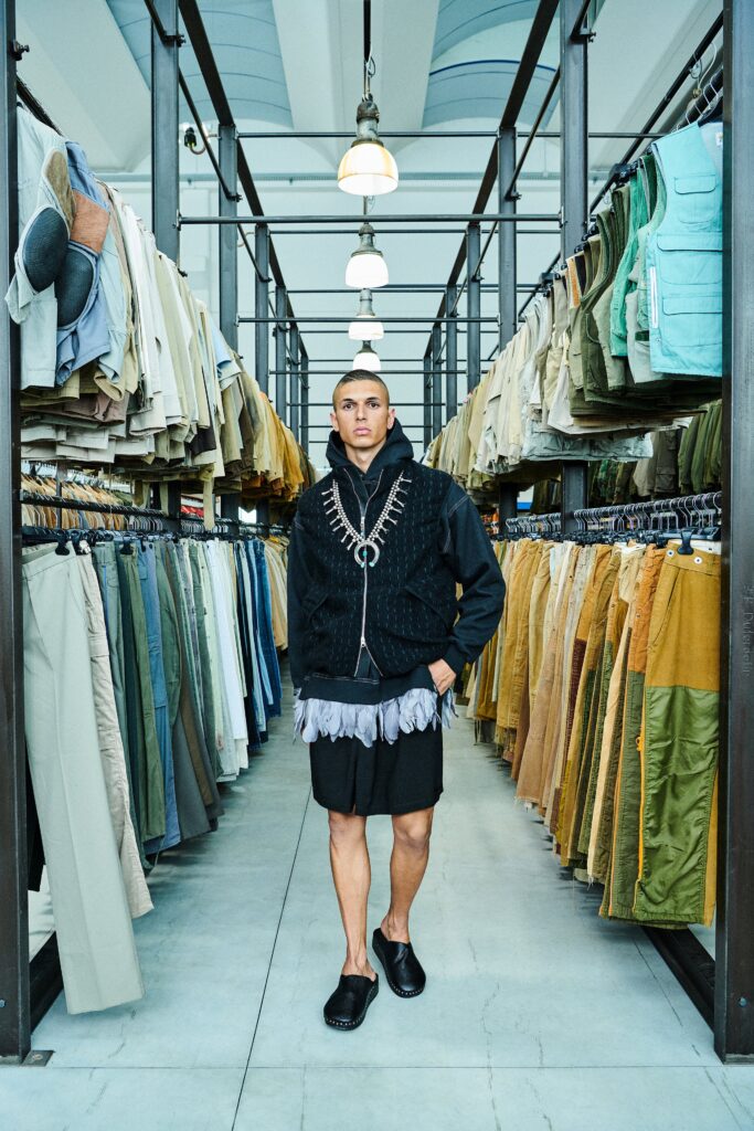 A relaxed black hoodie with long sleeves and layered shorts for a contemporary look.