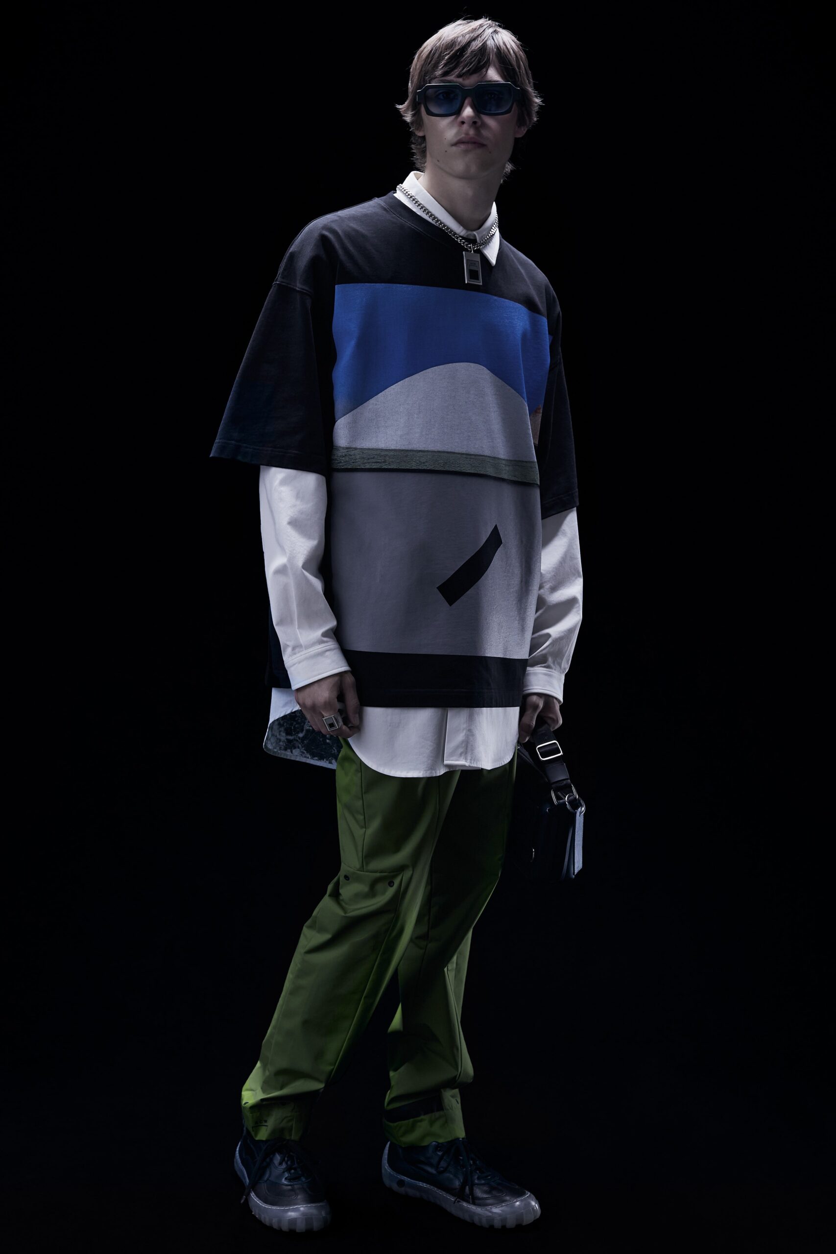 A relaxed fit color-blocked shirt with short sleeves paired with green pants.