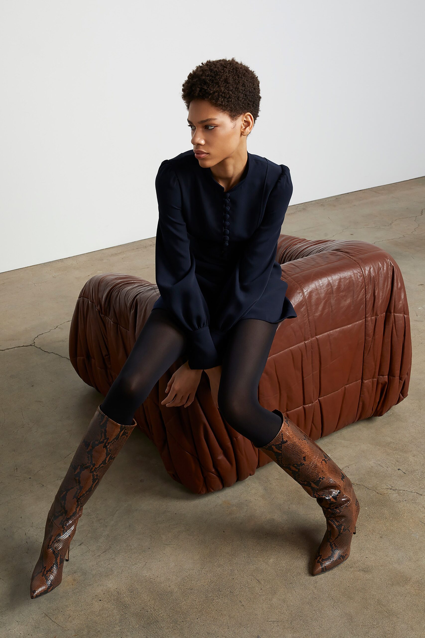 black fitted dress with leggings and boots