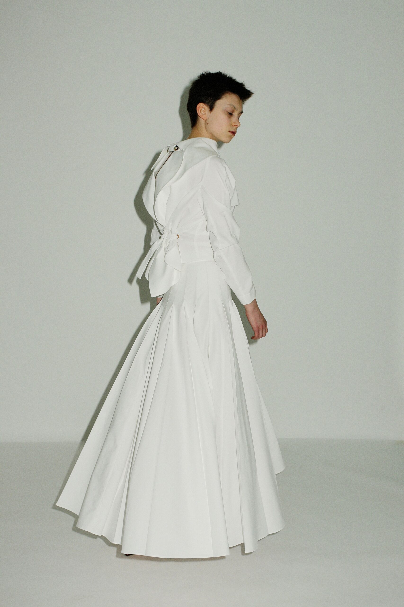 white pleated long-sleeve gown