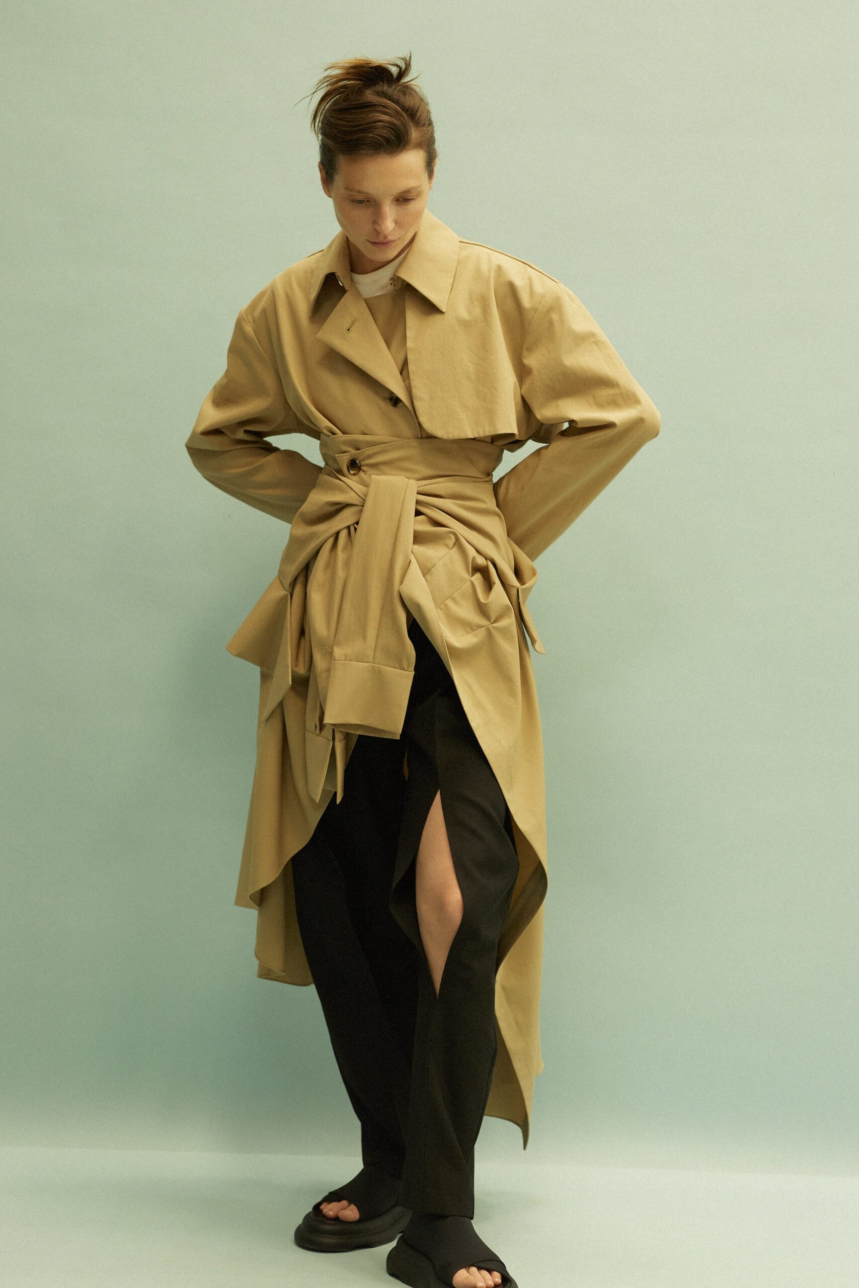 beige trench coat and black pants