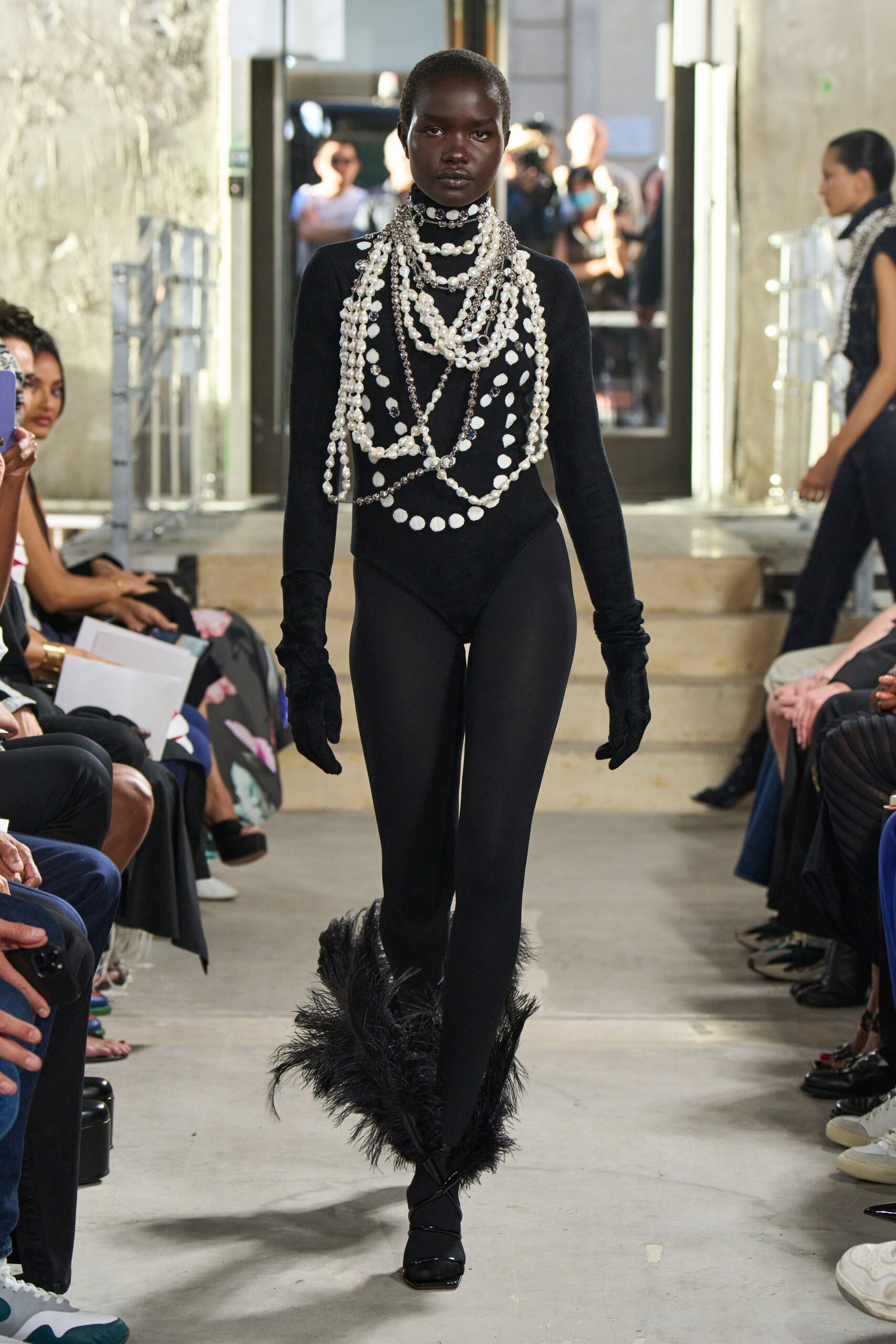 black fitted catsuit with pearls