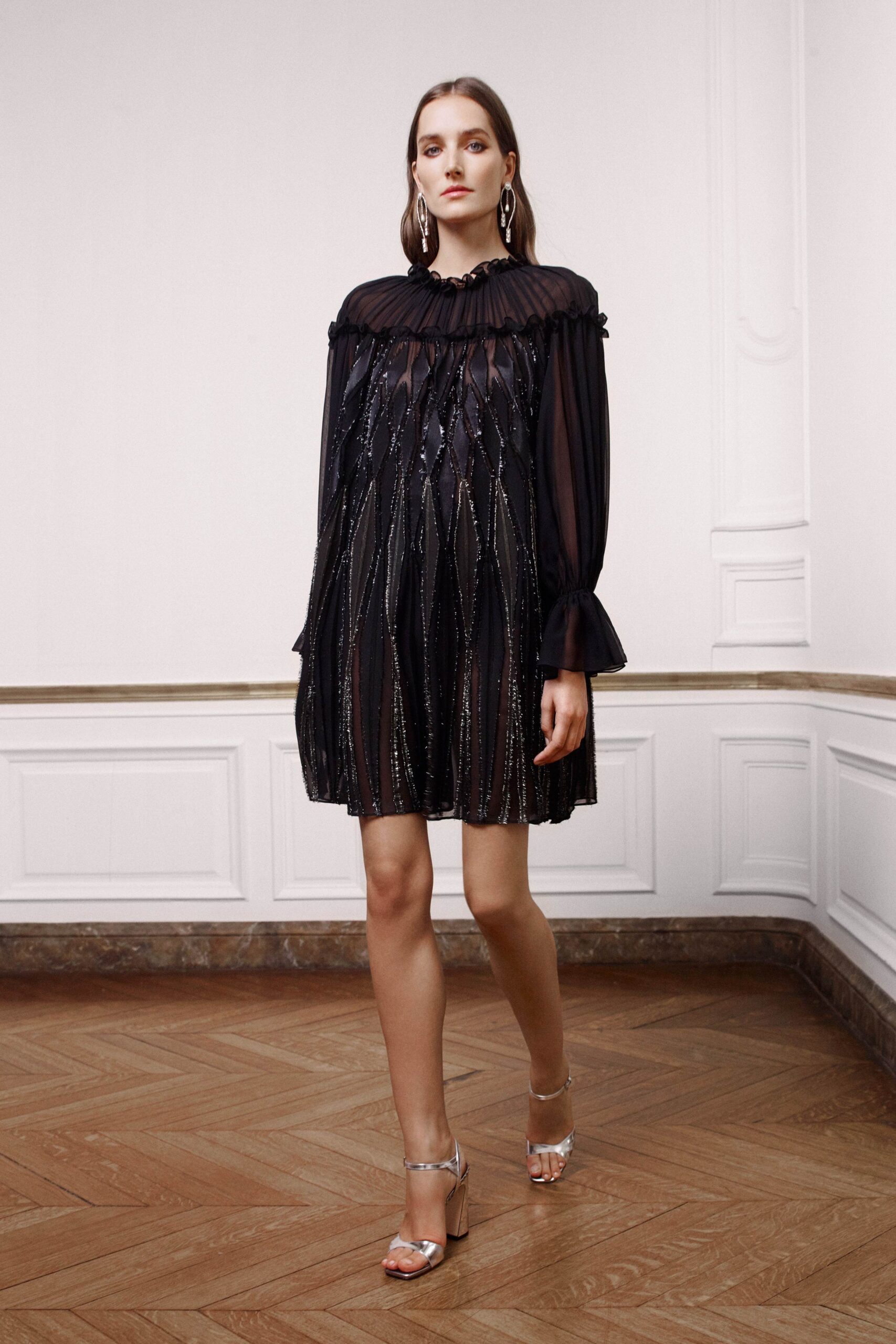 black pleated mini dress with silver shoes