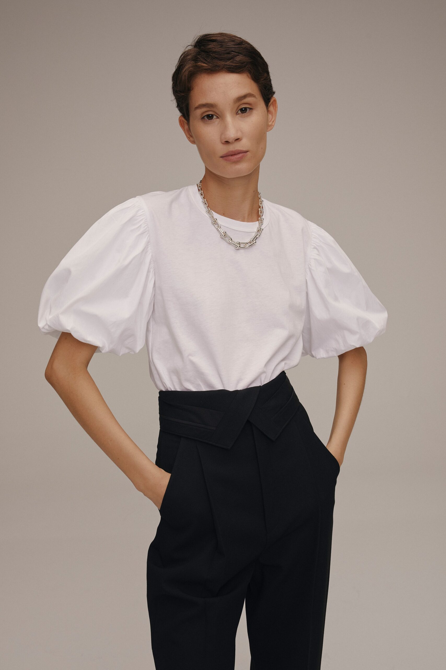 white puffed sleeve top and black tailored pants