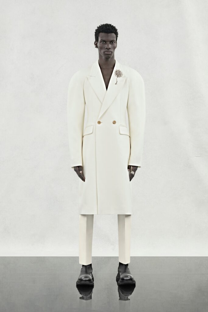 An oversized white wool coat with long sleeves and a double-breasted design.