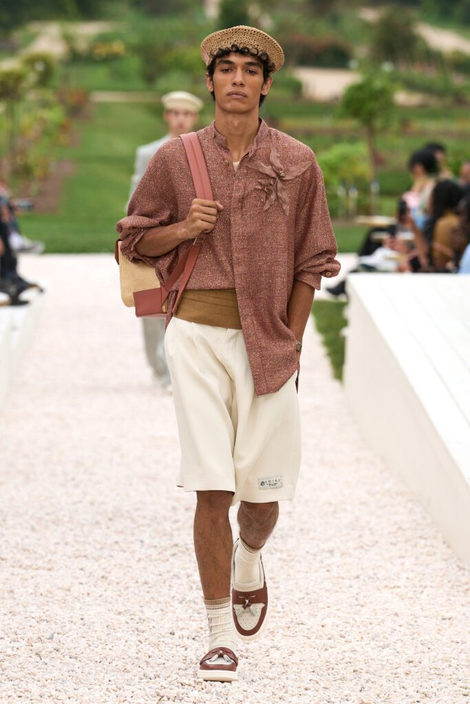A relaxed brown cotton long-sleeve shirt paired with white pleated shorts.