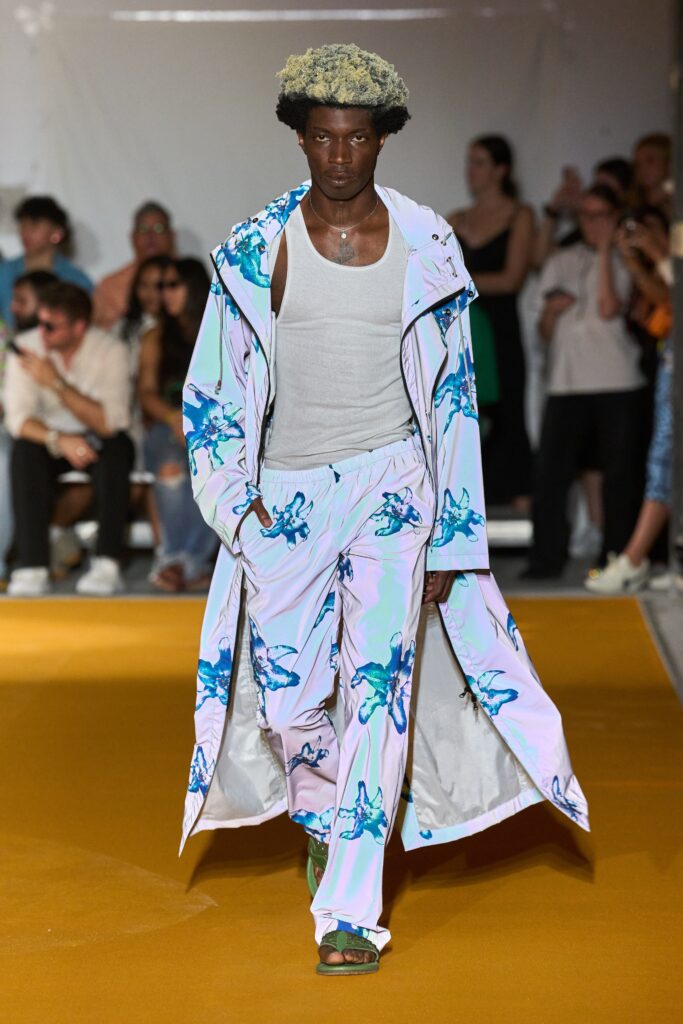 A relaxed fit printed white coat paired with matching pants, featuring a vibrant blue floral design.