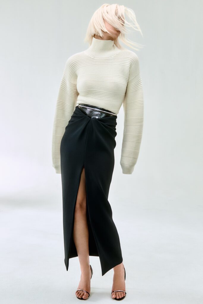 white knit turtleneck and black midi skirt