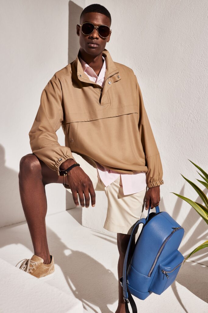 A relaxed beige jacket paired with a collared pink shirt, perfect for a casual look.