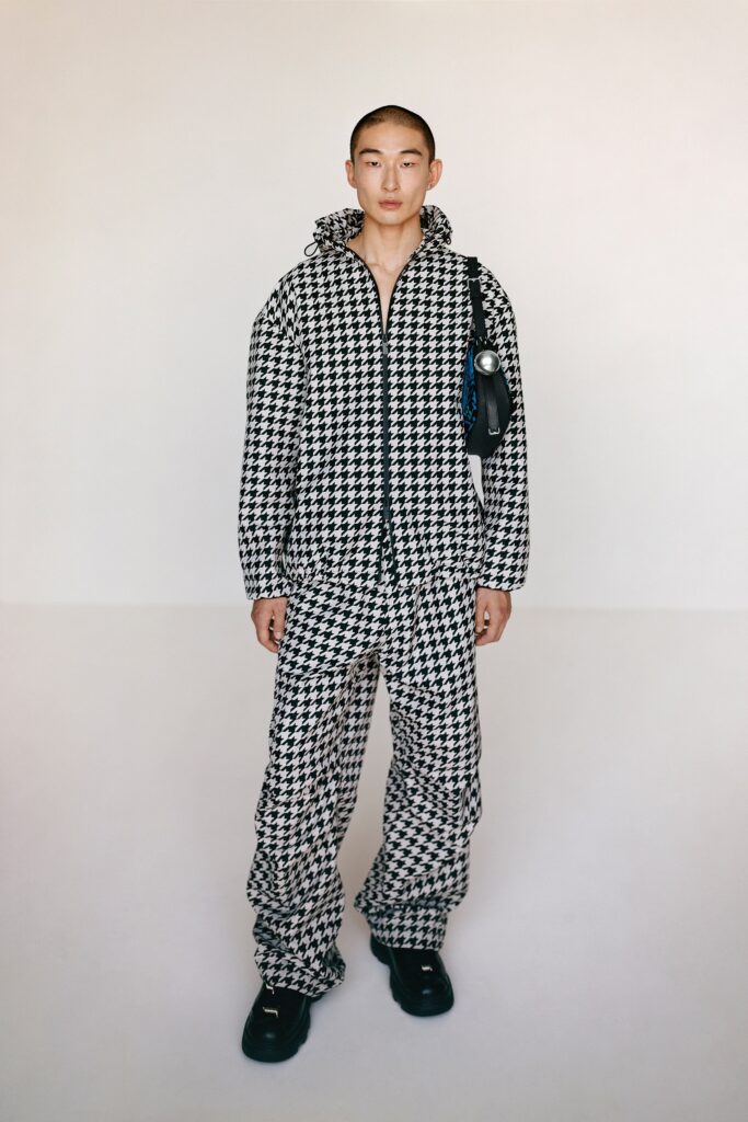A relaxed fit black and white checked jacket with matching pants, featuring a hood.