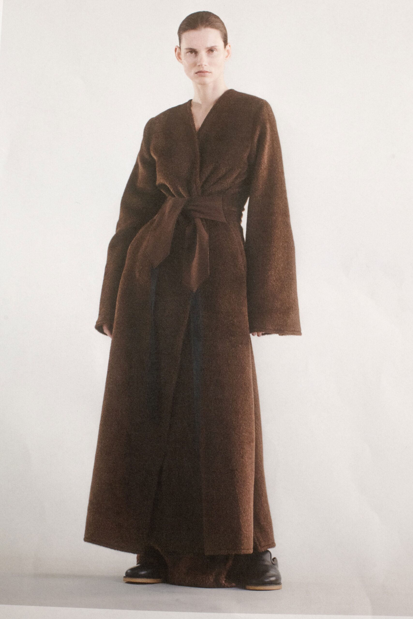 A relaxed brown wool dress with long sleeves, a V-neckline, and a belted waist.