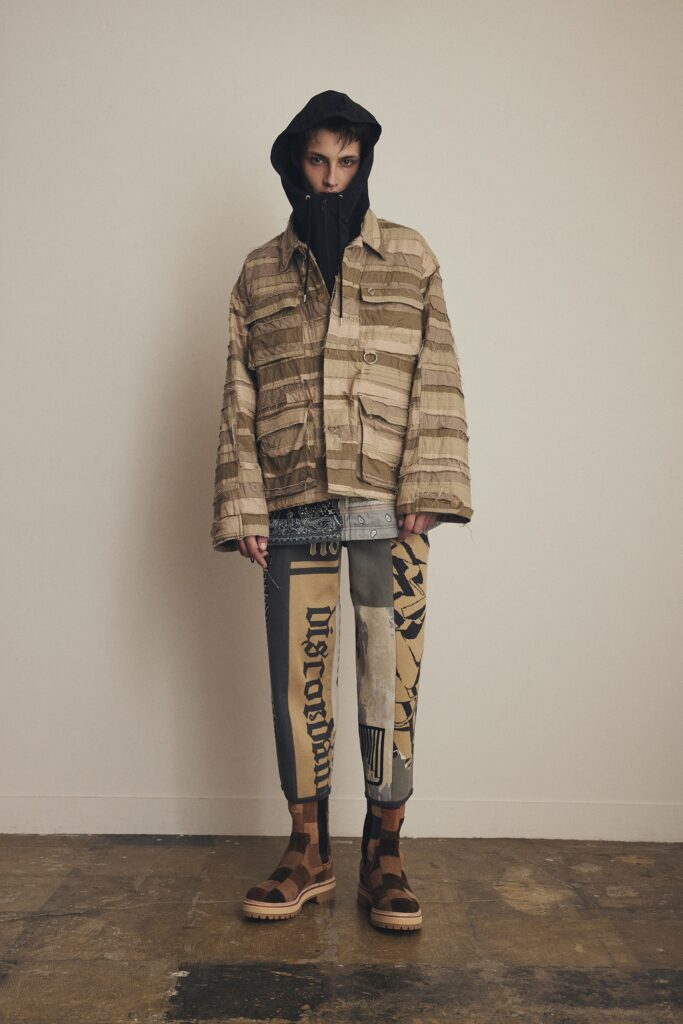 A relaxed brown and beige jacket with a hood paired with printed pants.