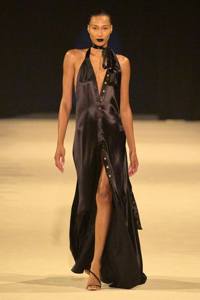 A fitted black silk dress with a V-neckline and a high slit for a dramatic effect.