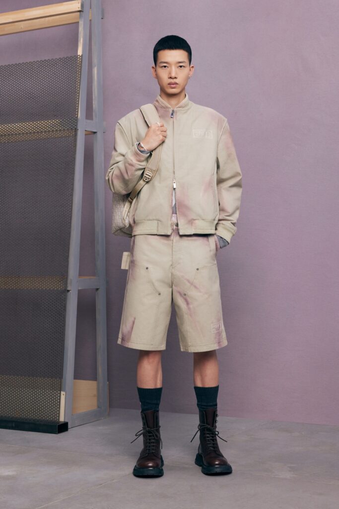 An oversized beige jacket paired with matching shorts, creating a relaxed summer look.