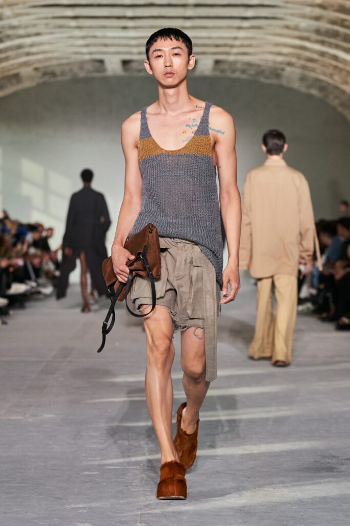 A relaxed gray cotton sleeveless top paired with beige shorts, featuring a layered design.