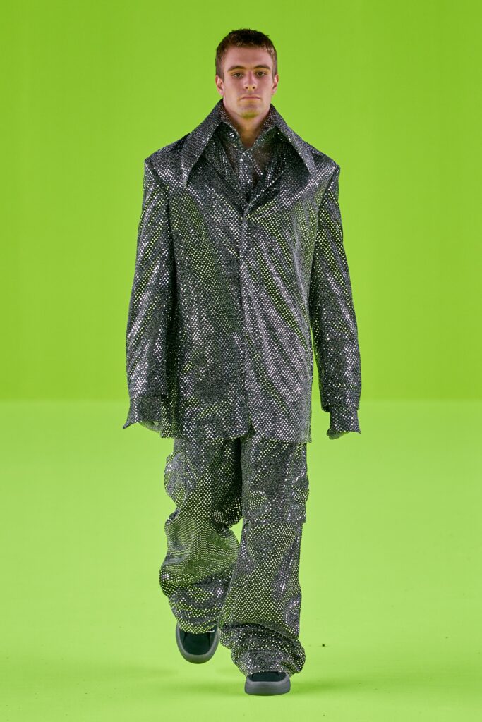 An oversized silver metallic suit with long sleeves and a collared design.