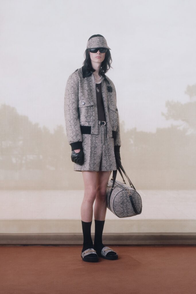 A fitted black and white printed jacket paired with a matching skirt, featuring an asymmetric design.