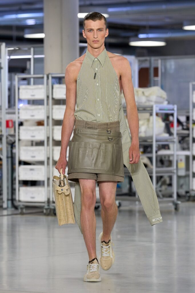 A fitted beige striped sleeveless shirt paired with matching fitted shorts.