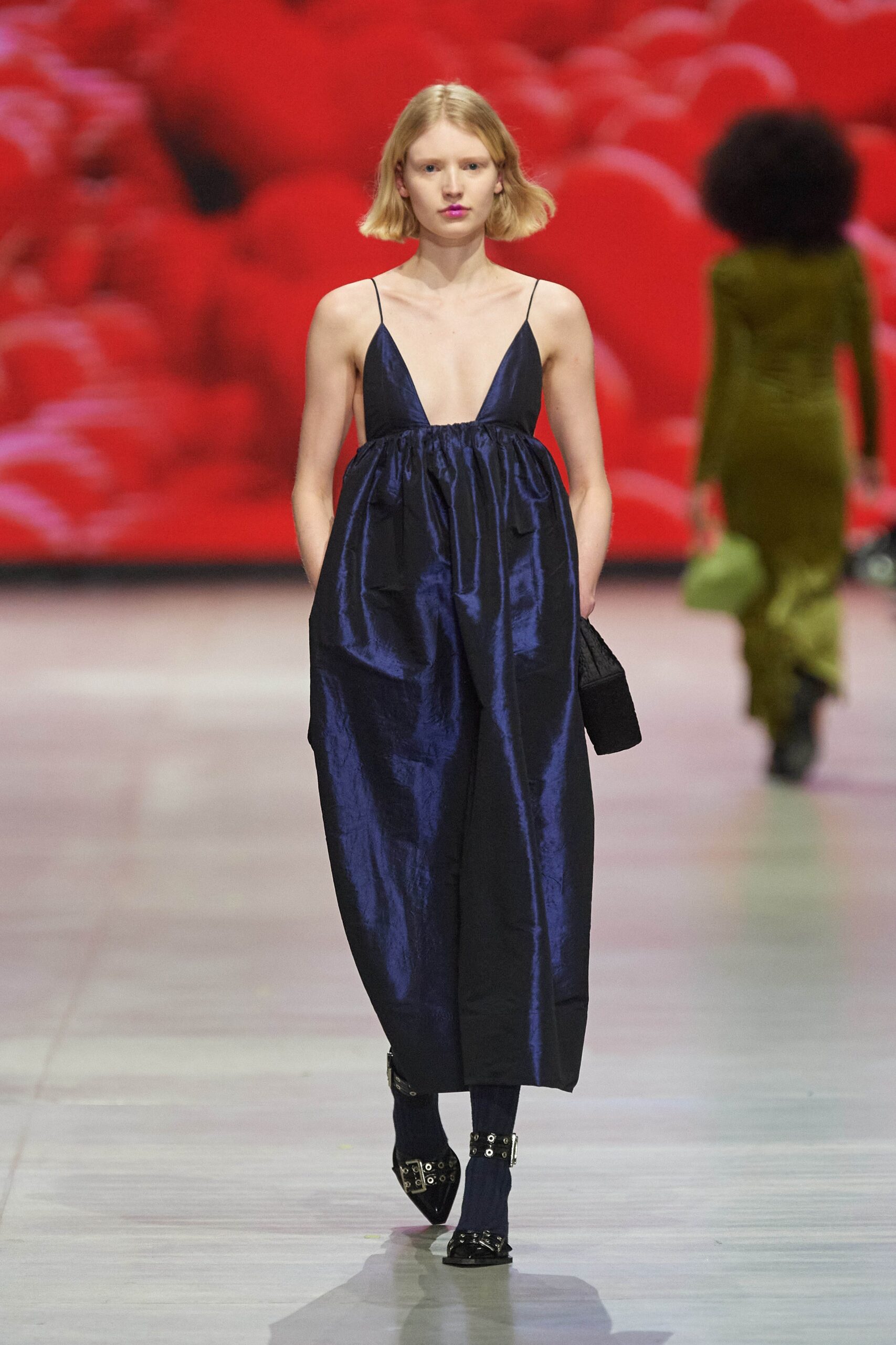 A relaxed blue silk sleeveless dress with a V-neckline and asymmetric design.