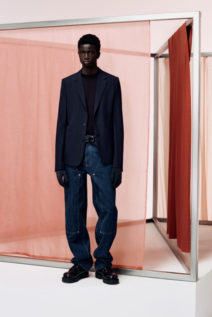 A relaxed navy blazer paired with blue straight-leg pants for a modern look.