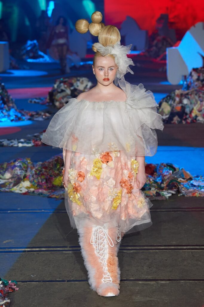 A relaxed white and pink floral dress with an off-shoulder design and tiered layers.