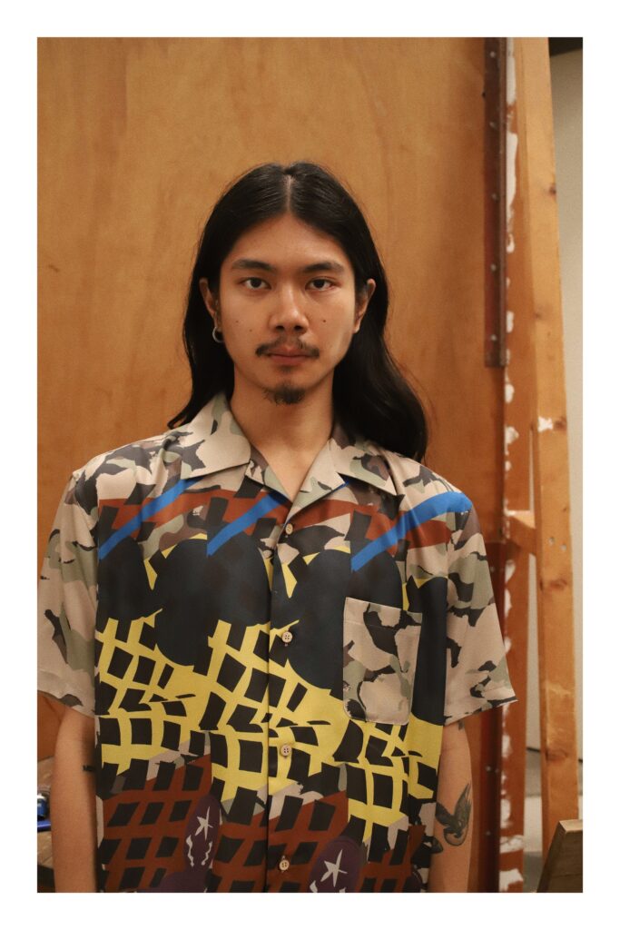 A multicolor cotton short-sleeve shirt featuring a bold graphic print and button closure.