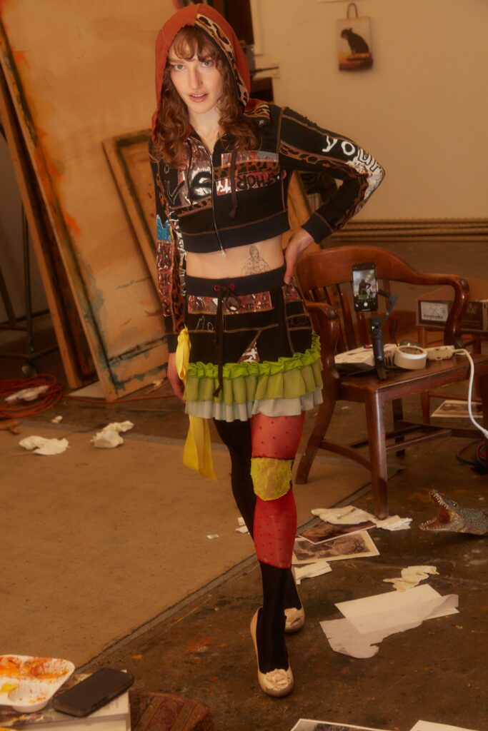 A fitted black crop-top and layered skirt featuring vibrant colors and printed designs.