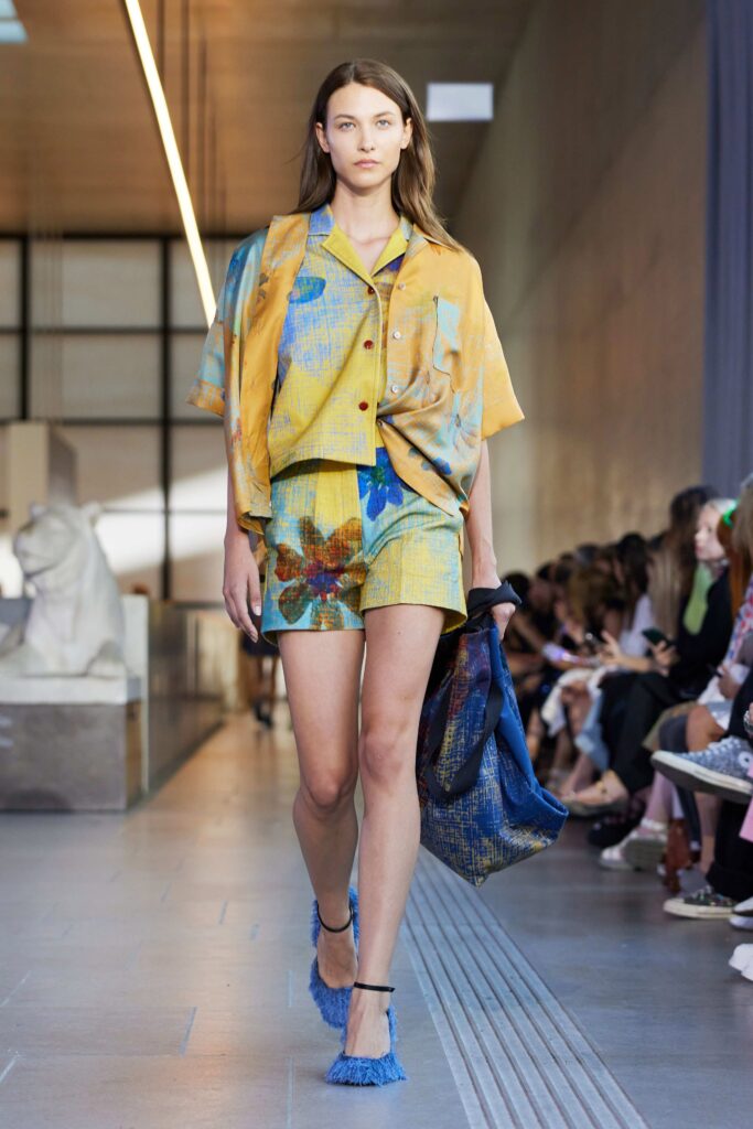A short-sleeve yellow and blue printed shirt paired with matching shorts for a vibrant summer look.