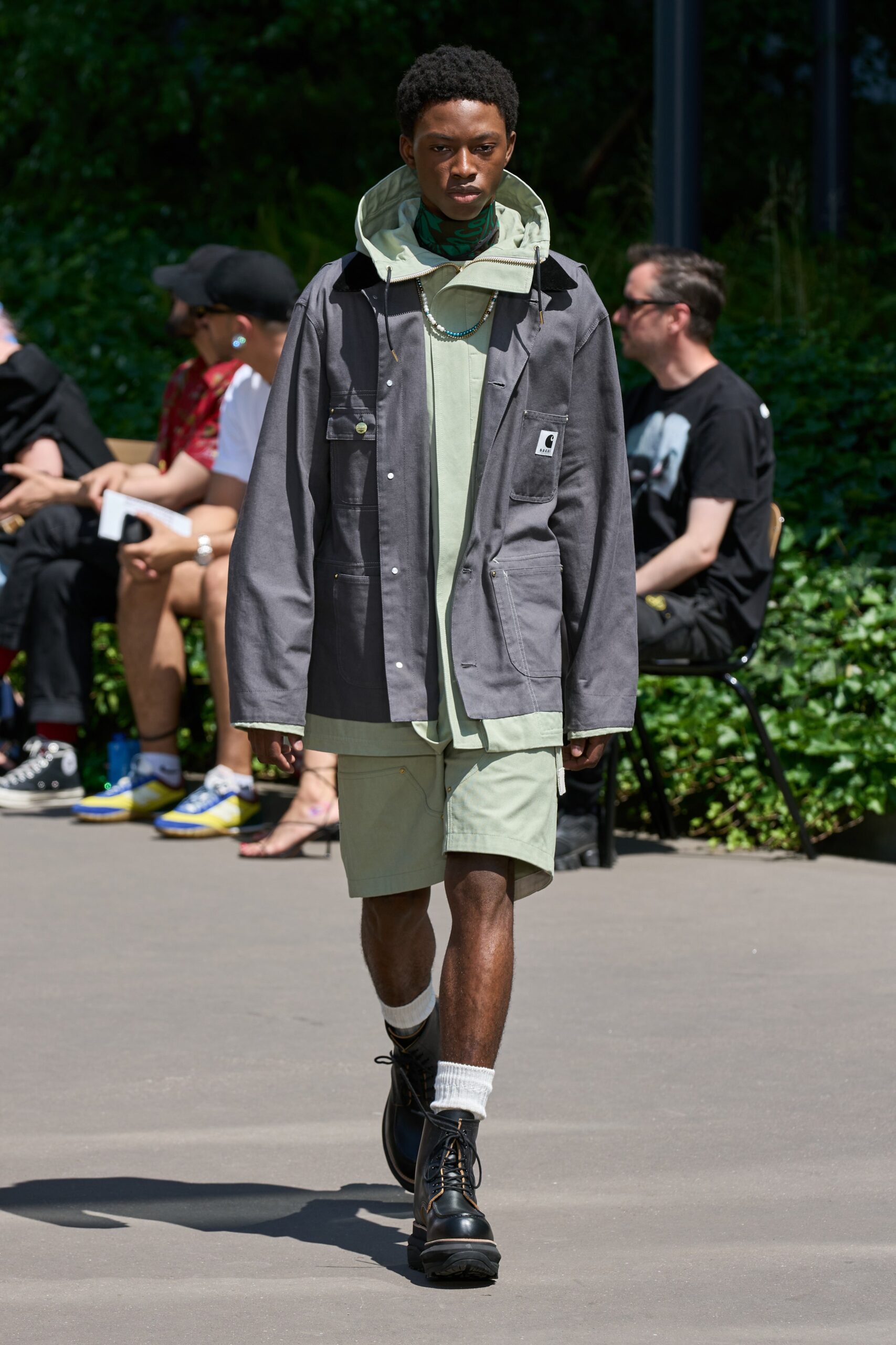 gray jacket green top and shorts