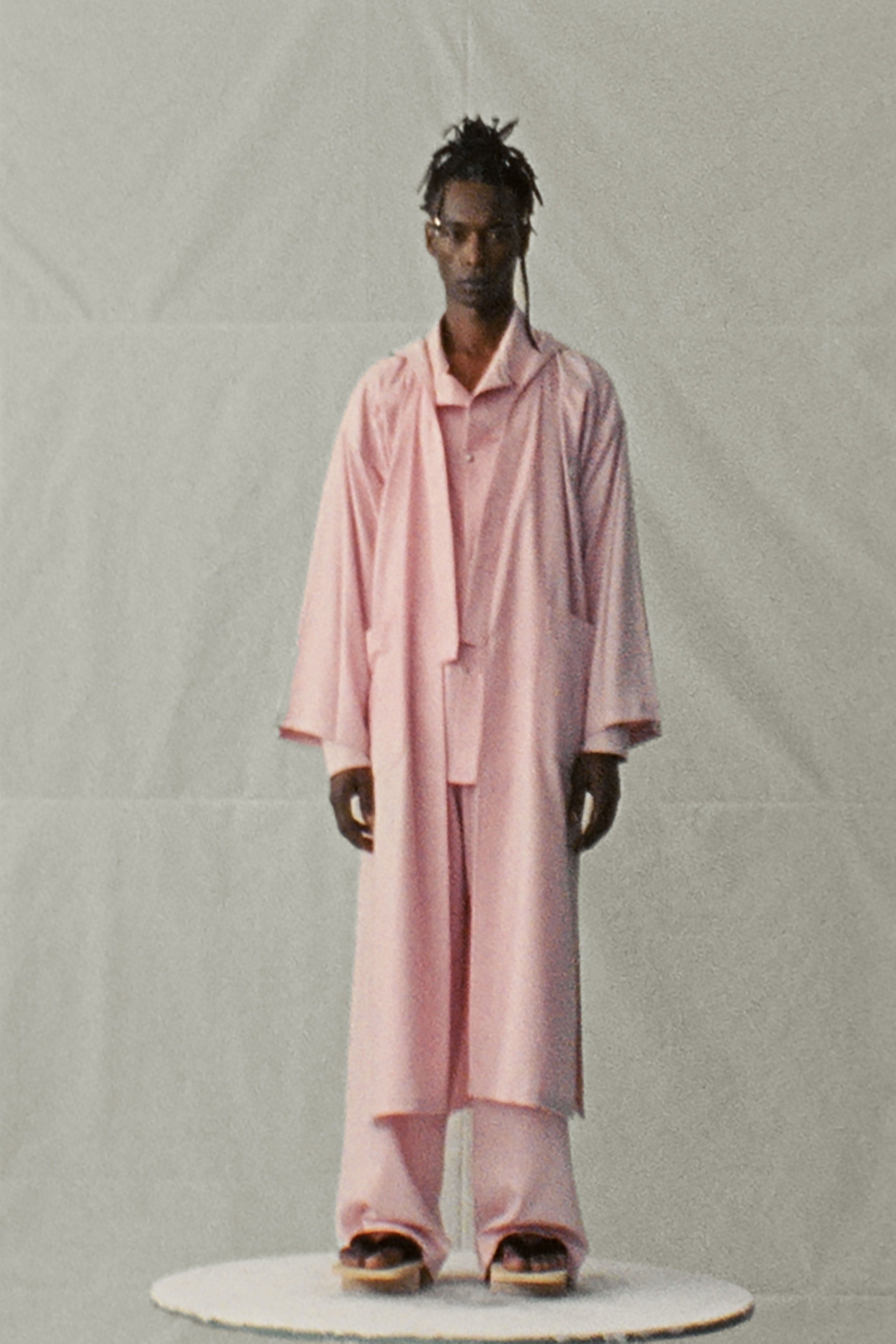 A relaxed pink cotton jacket with long sleeves and collared design paired with matching pants.