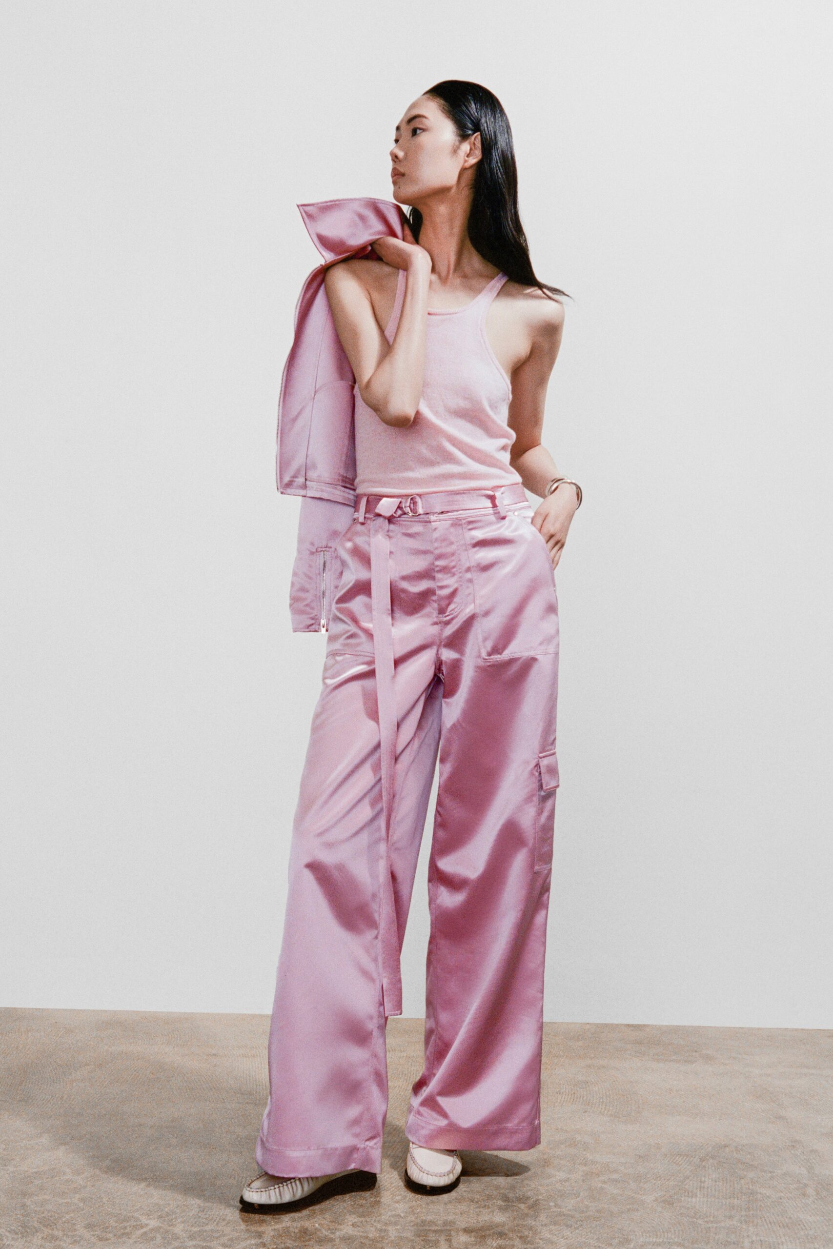 A relaxed pink silk sleeveless top paired with wide-leg pants for a chic look.