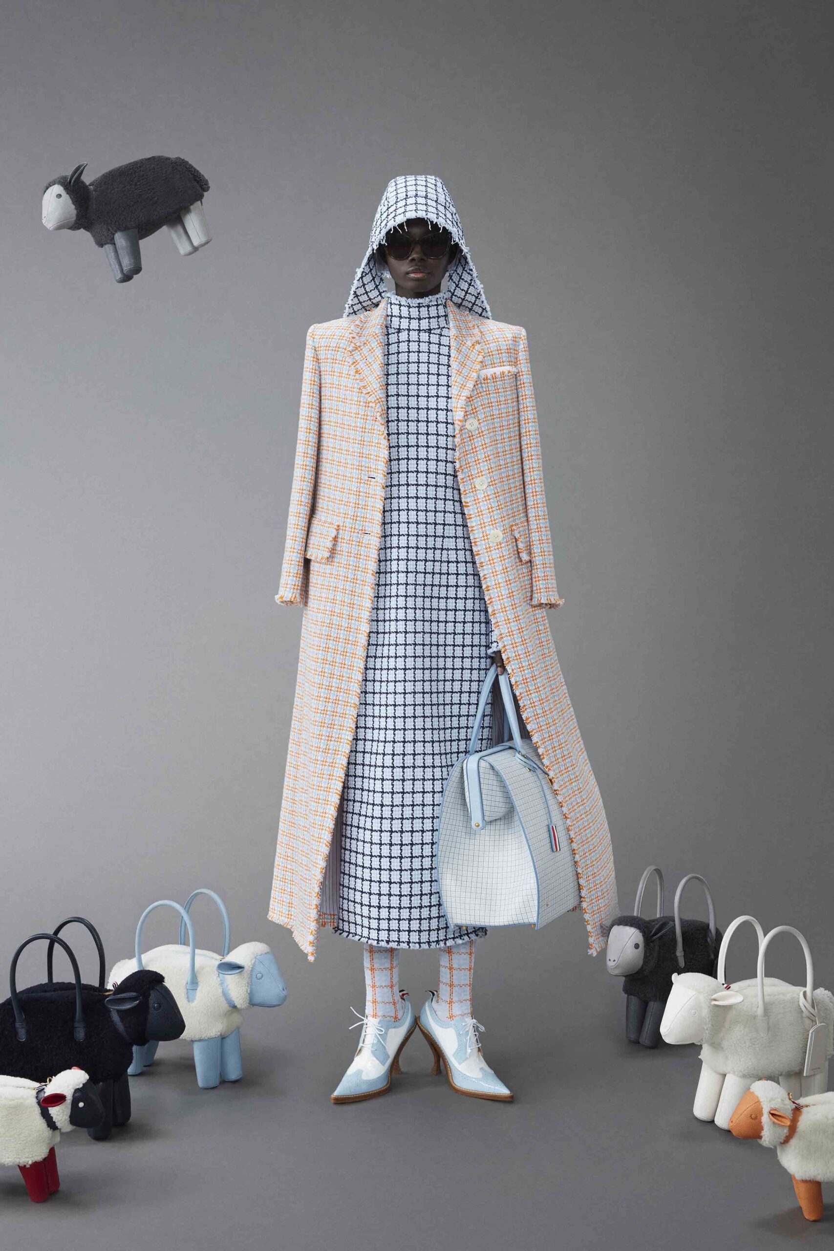 A relaxed blue and orange checked coat dress with long sleeves and a collared neckline.