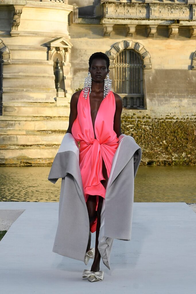 pink draped mini dress with gray coat