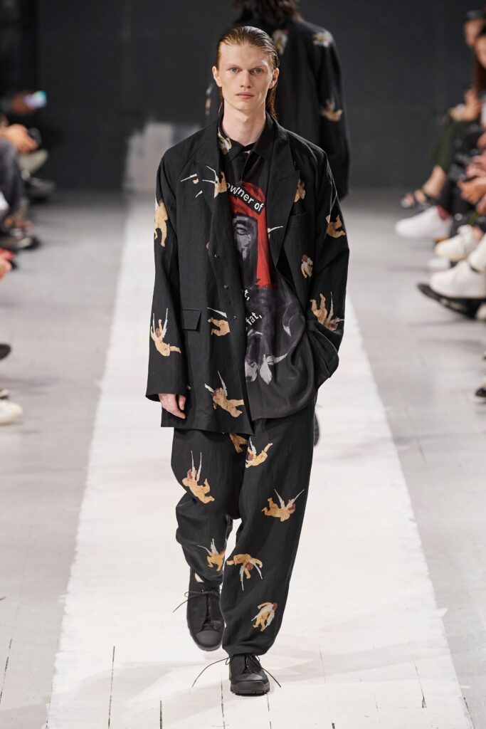 A relaxed black cotton jacket with long sleeves and printed design, paired with matching pants.
