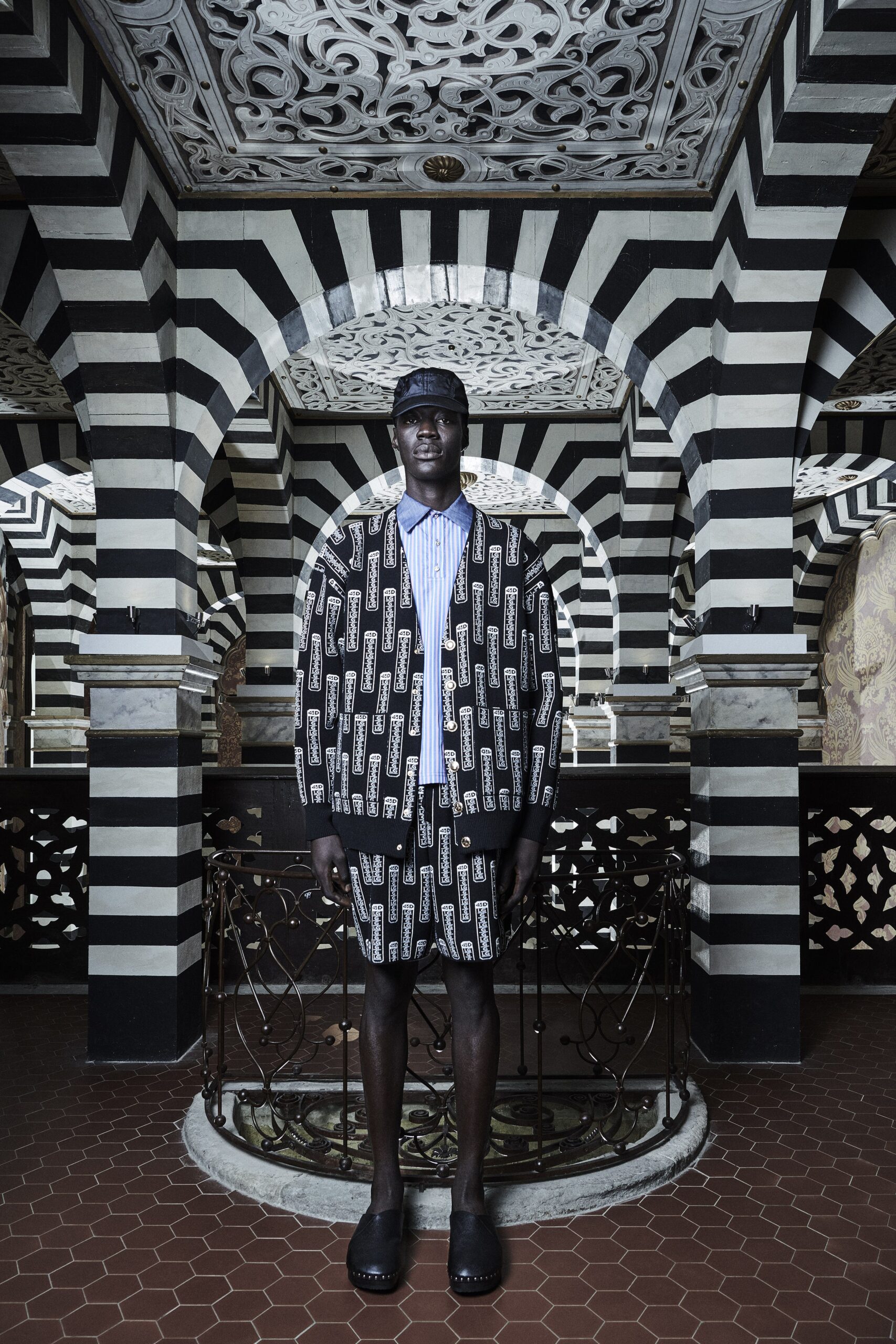 A relaxed black and white printed jacket paired with matching shorts, featuring a collared design.