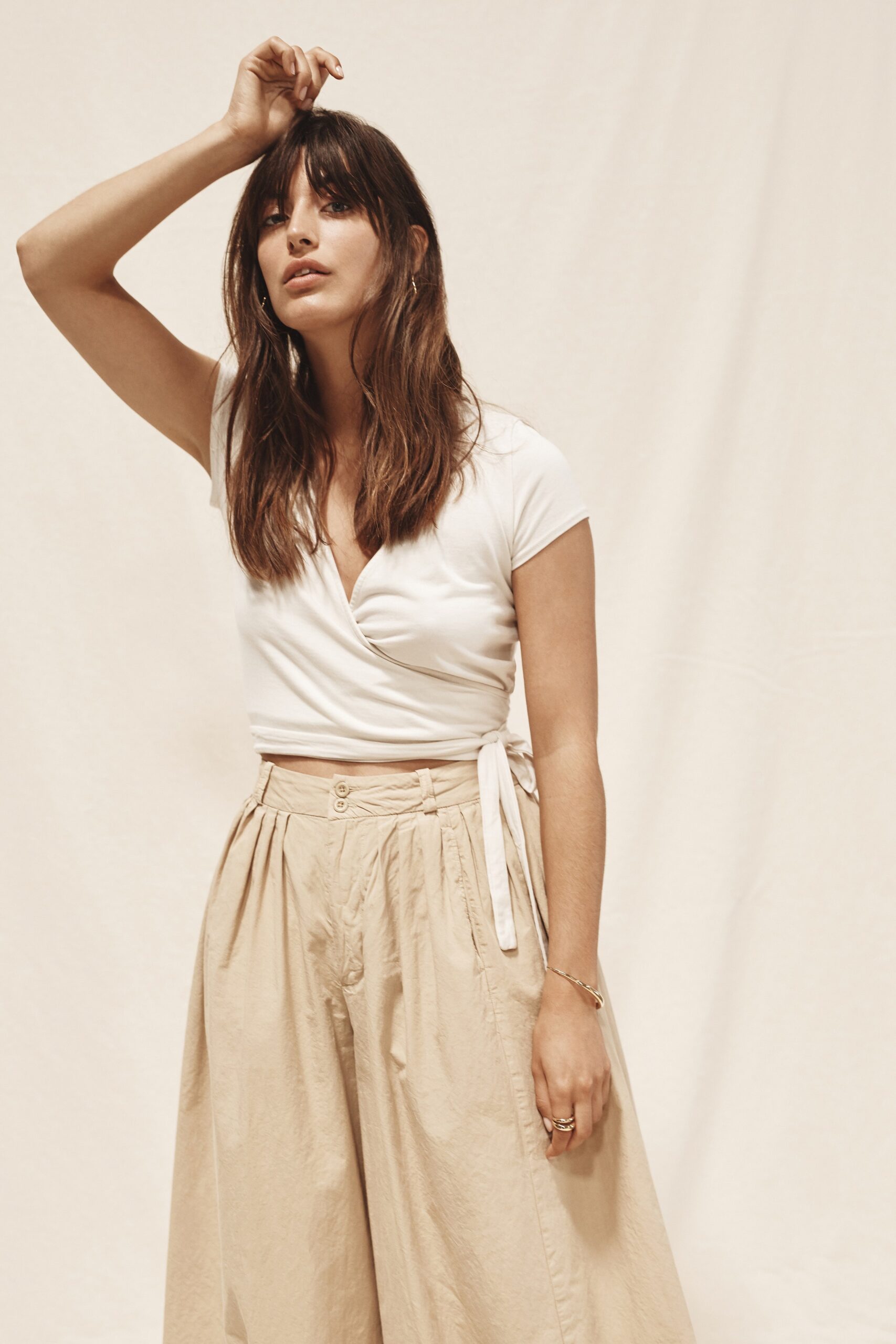 white fitted top with beige pants