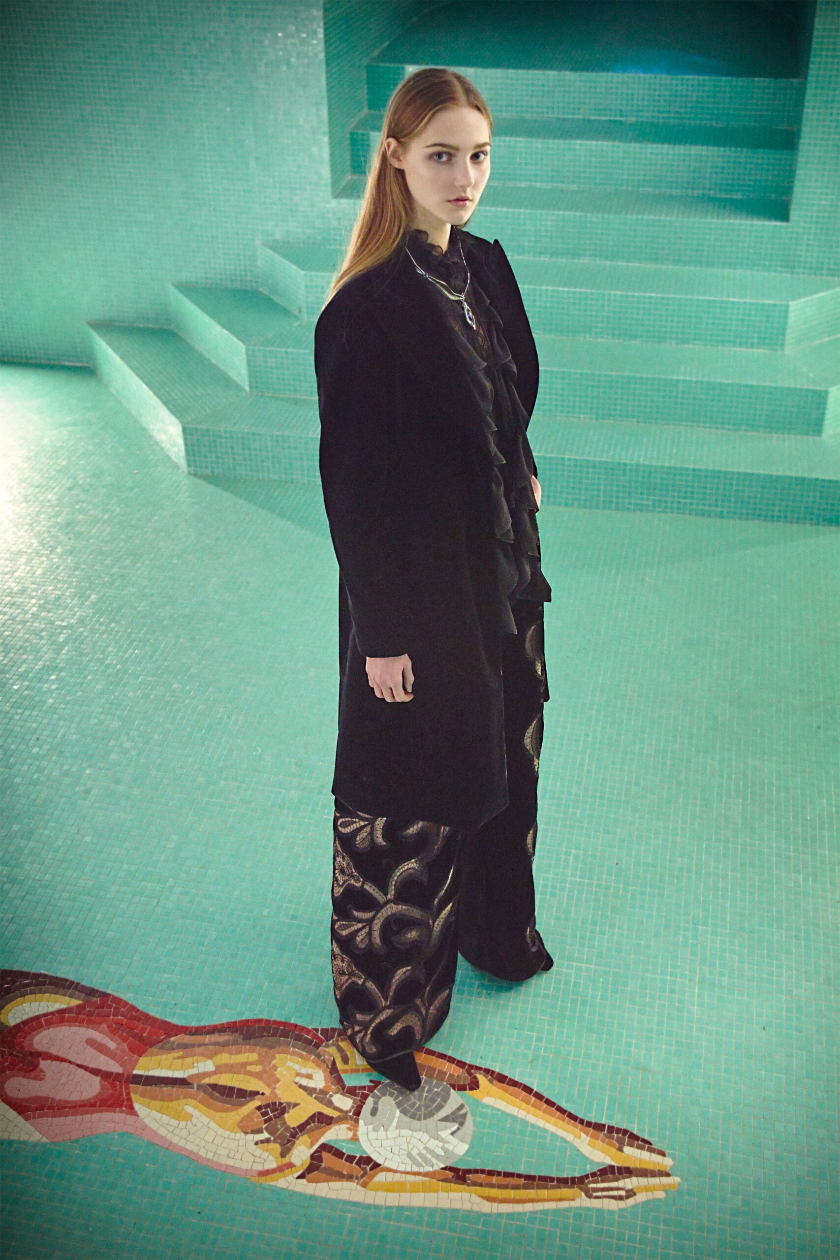 black wool coat with ruffled blouse