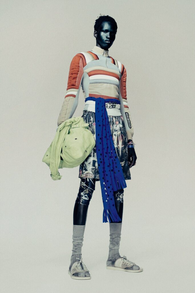 A relaxed long-sleeve striped top paired with a printed skirt, showcasing vibrant colors.