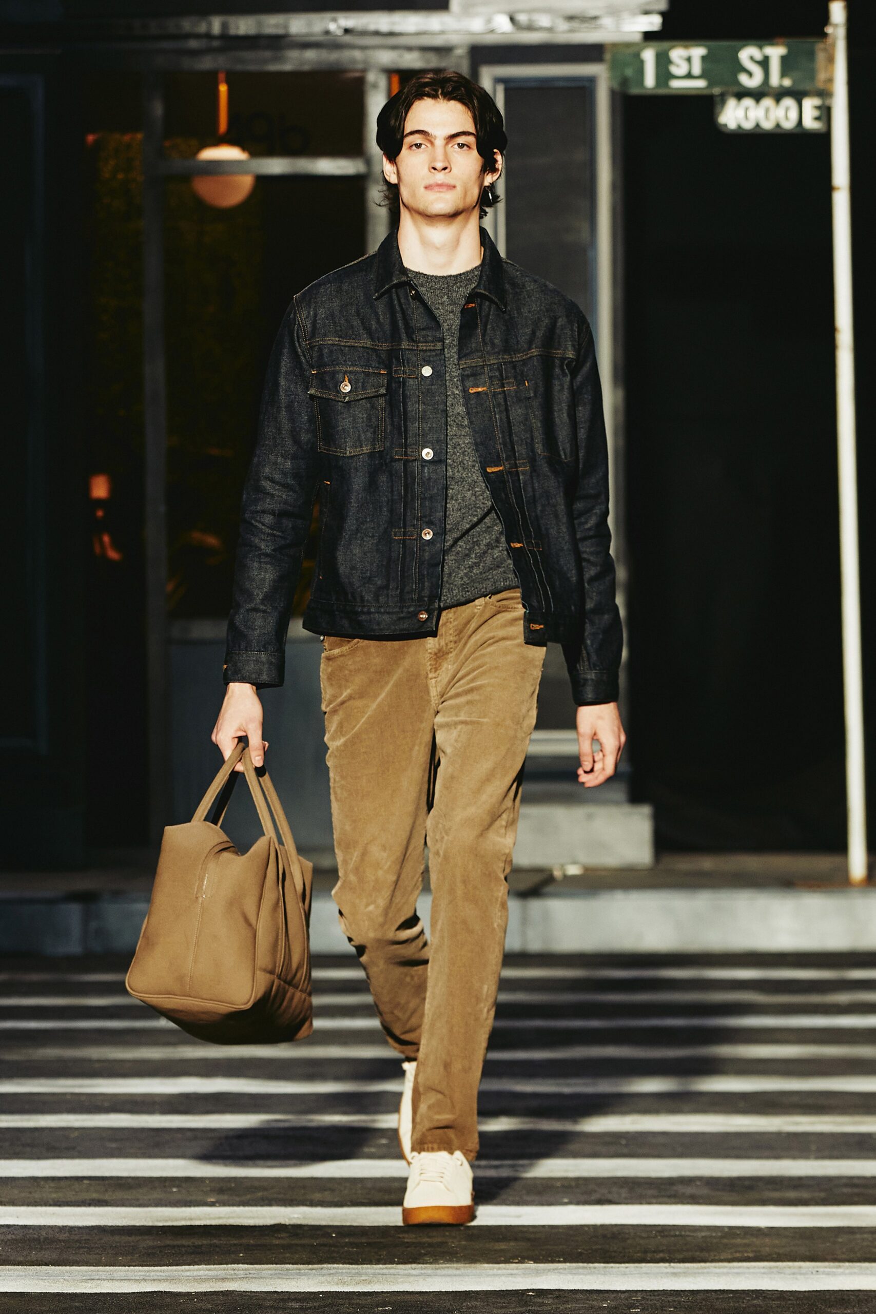 A relaxed blue denim jacket paired with straight-leg brown cotton pants.