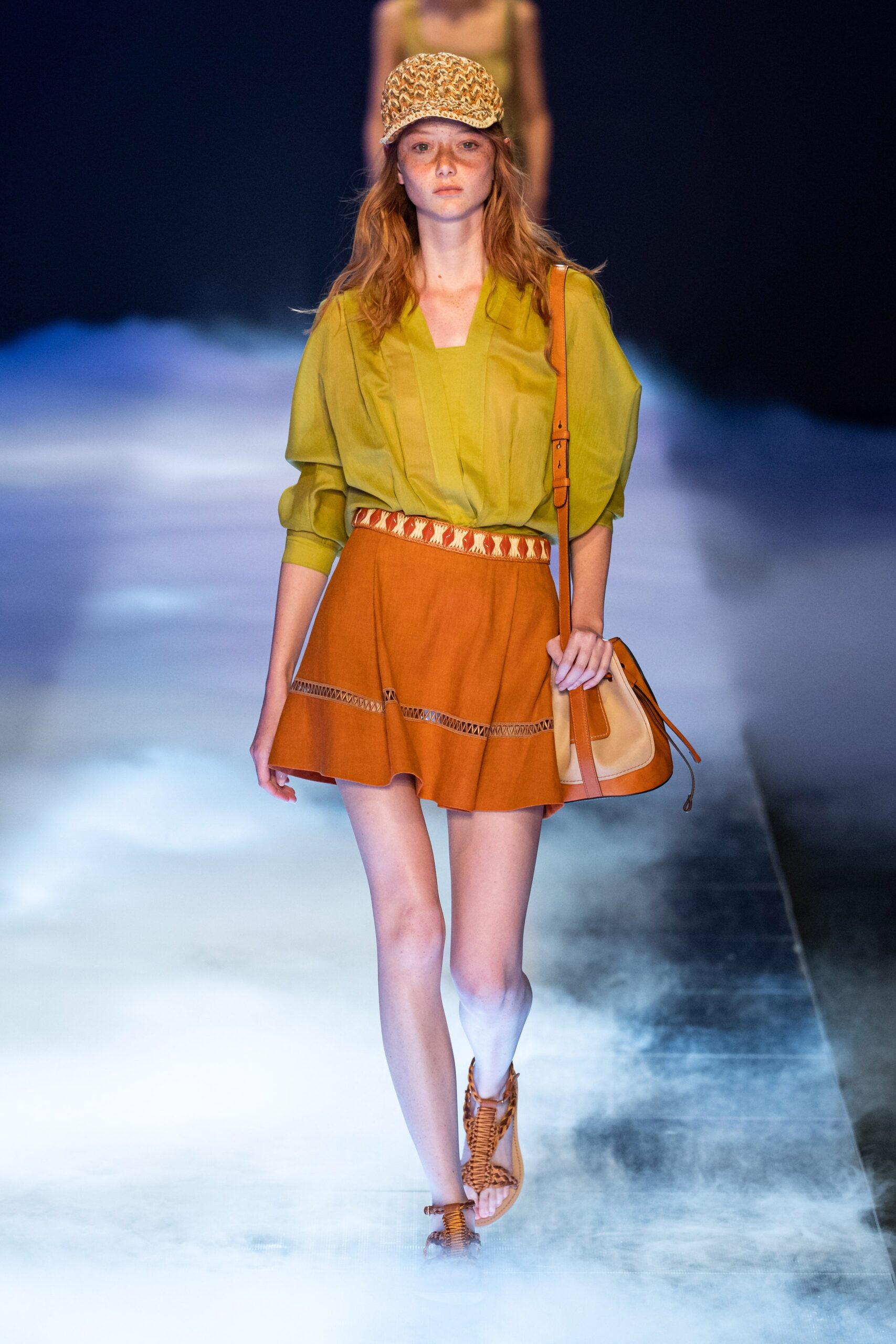 green blouse and orange skirt