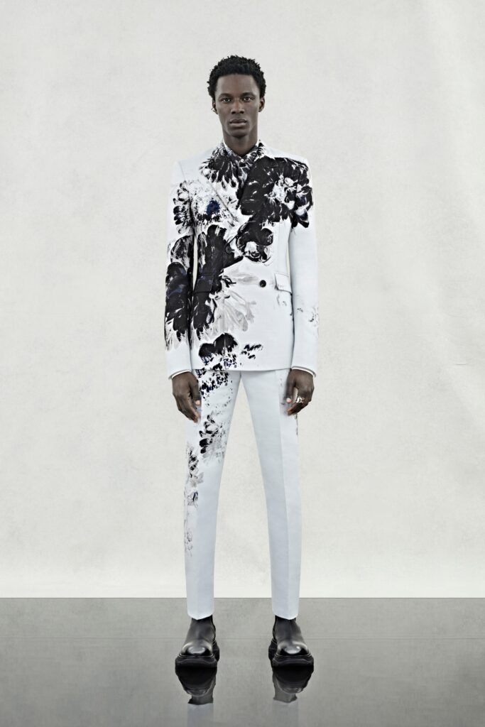 A tailored black and white printed suit with long sleeves and a collared design.