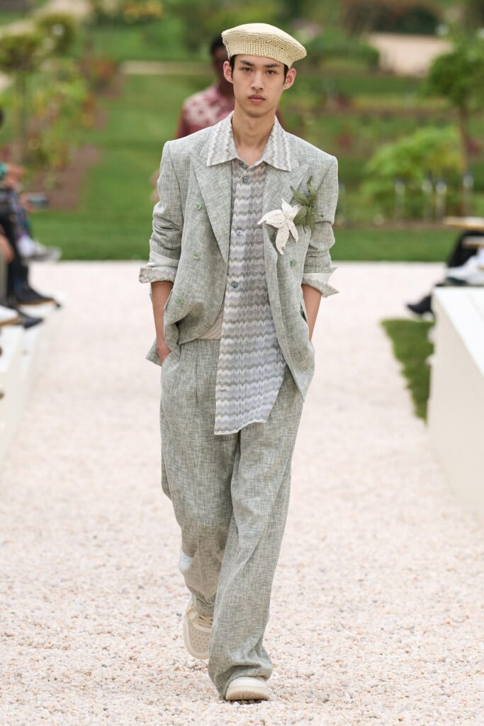 A relaxed beige cotton suit with long sleeves and a collared shirt featuring a striped pattern.