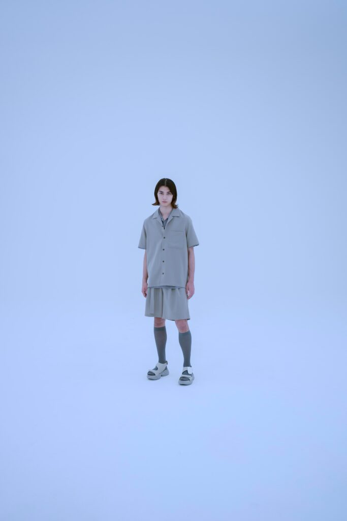 A relaxed gray cotton shirt with a collared neckline paired with a matching skirt.
